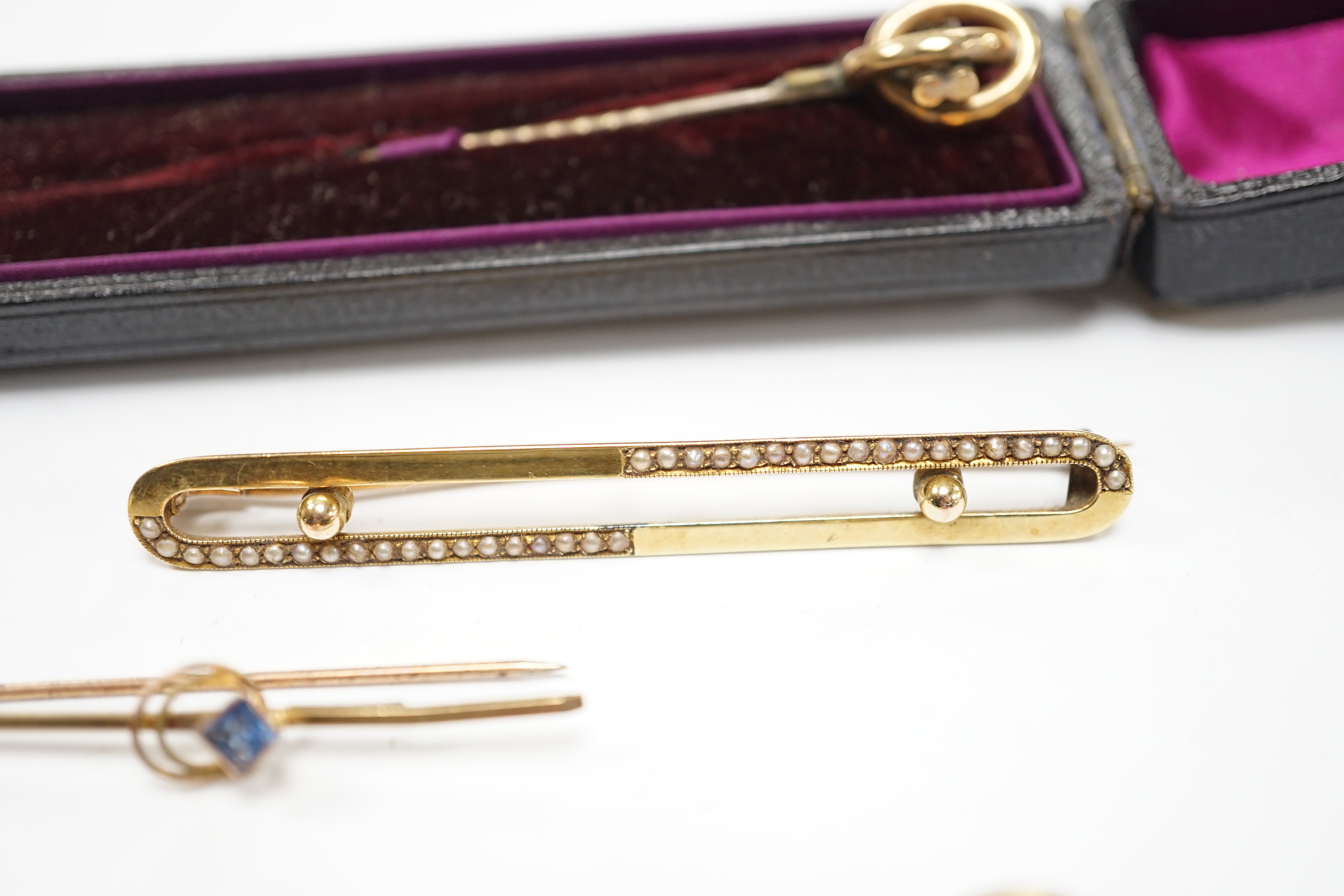 An Edwardian 15ct and seed pearl set bar brooch, 64mm, gross 4.9 grams, a 9ct bar brooch, two stick pins and a pair of 9ct and simulated pearl set drop earrings.